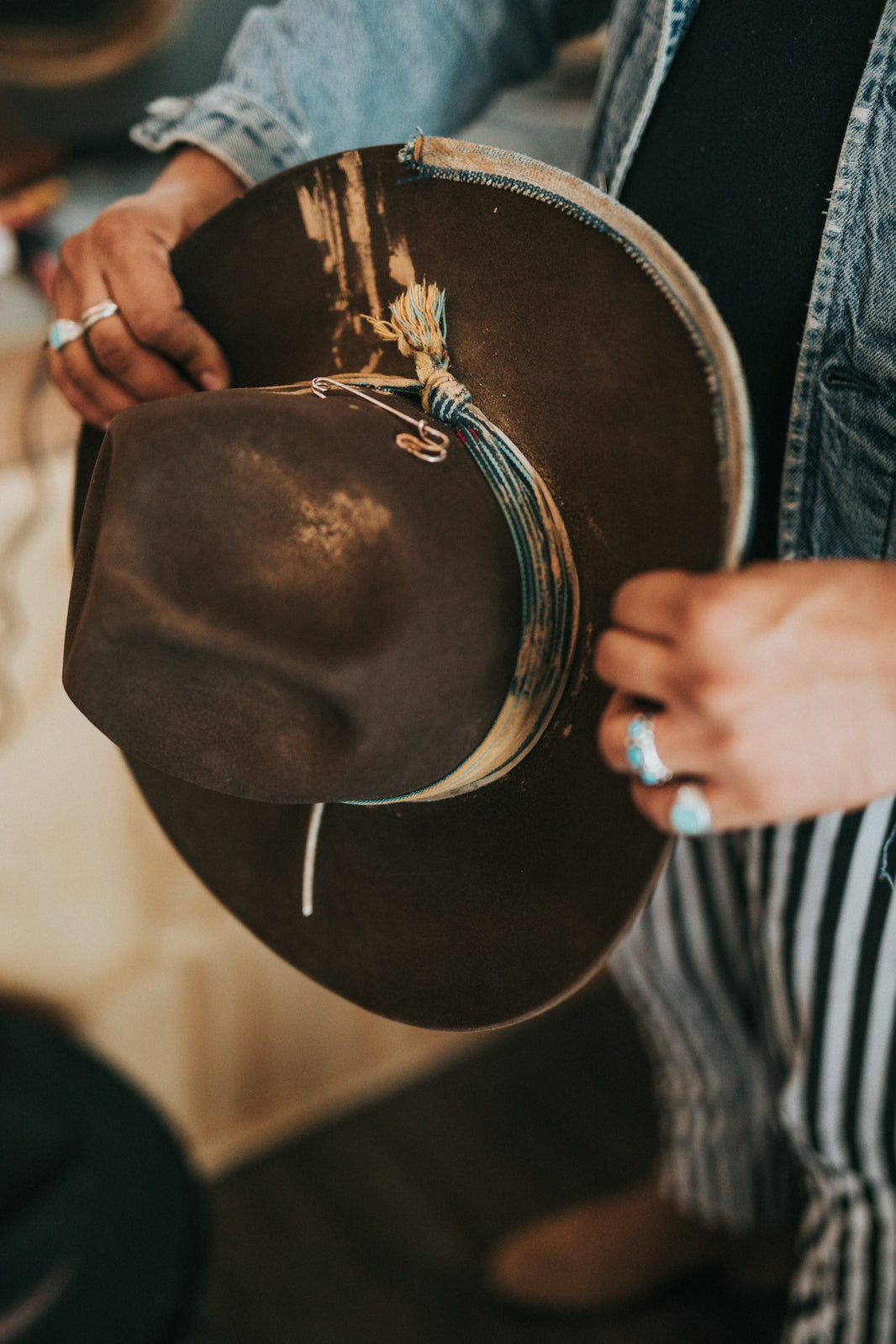 person holding brown cowboy hat