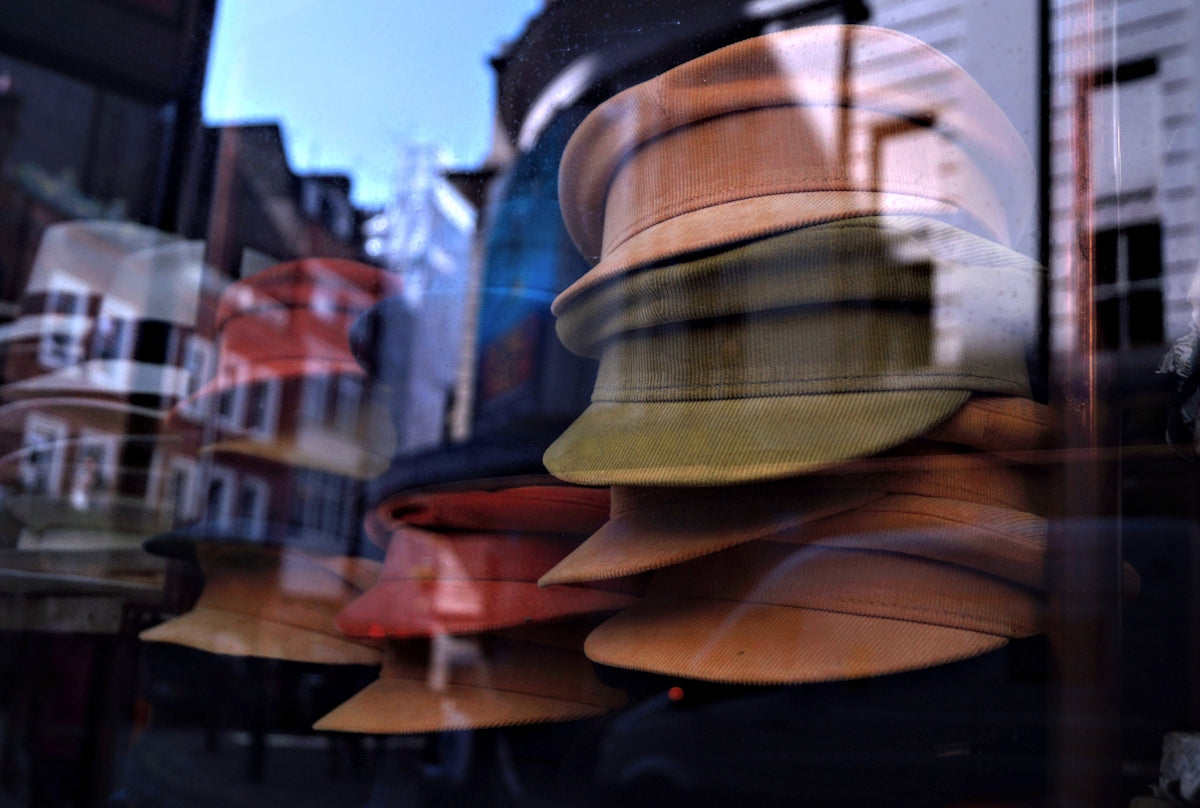 brown and black hat on brown wooden table