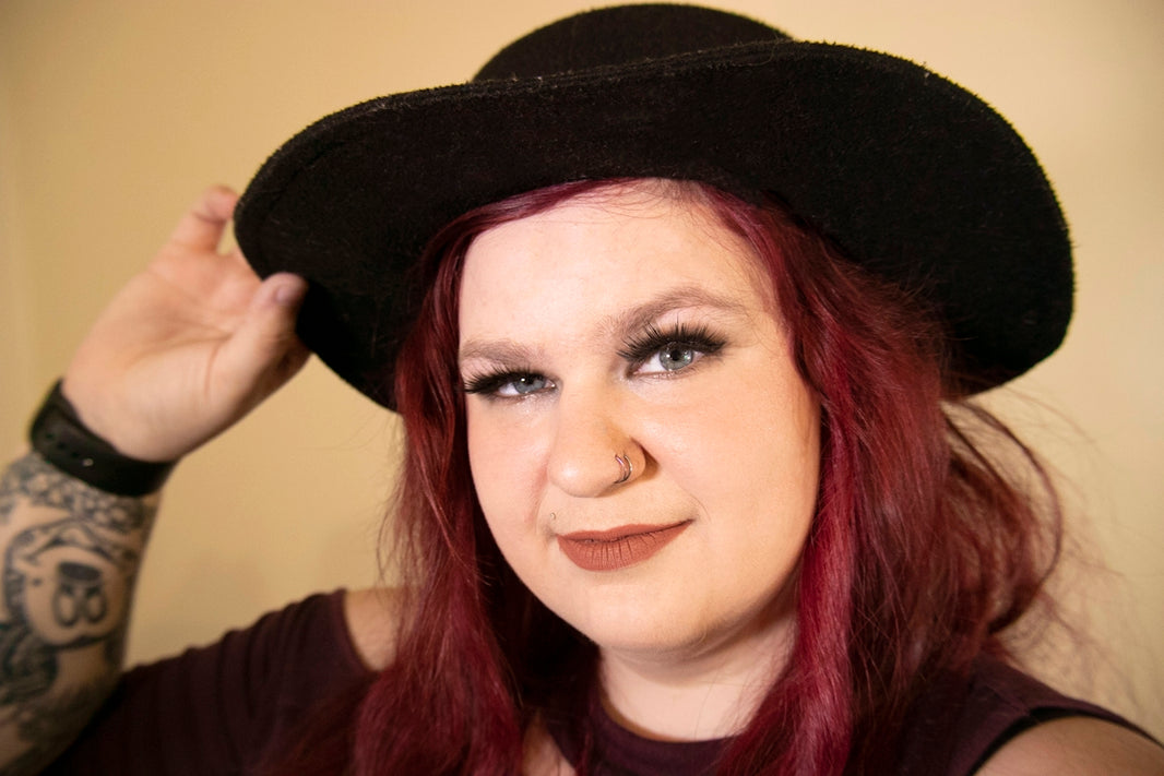 woman in black hat smiling