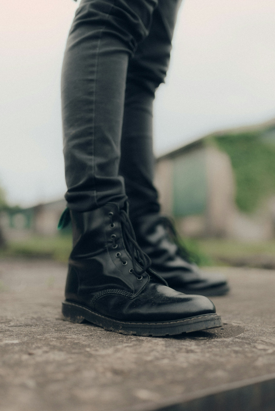 person in black leather boots