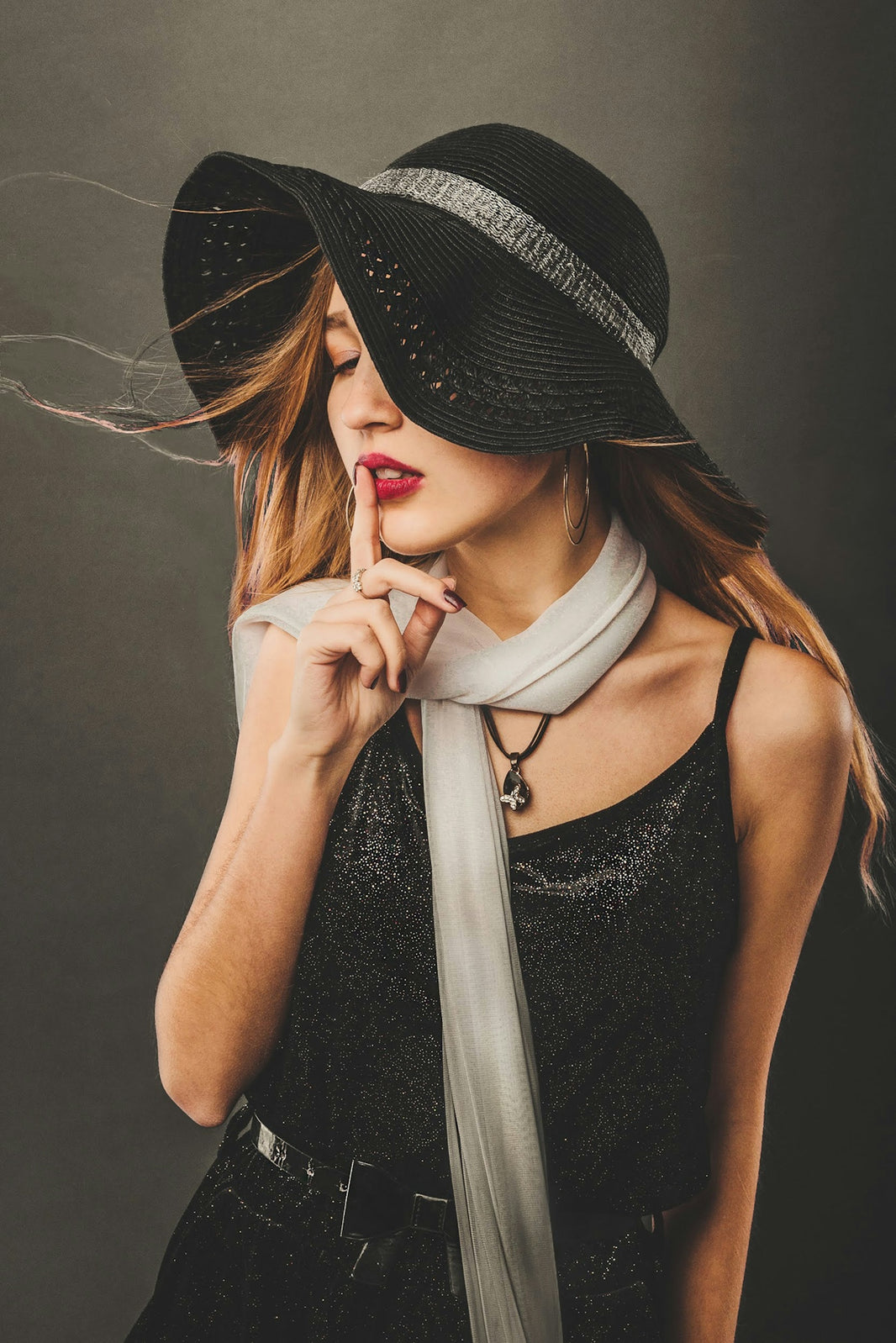 woman in black tank top wearing black hat