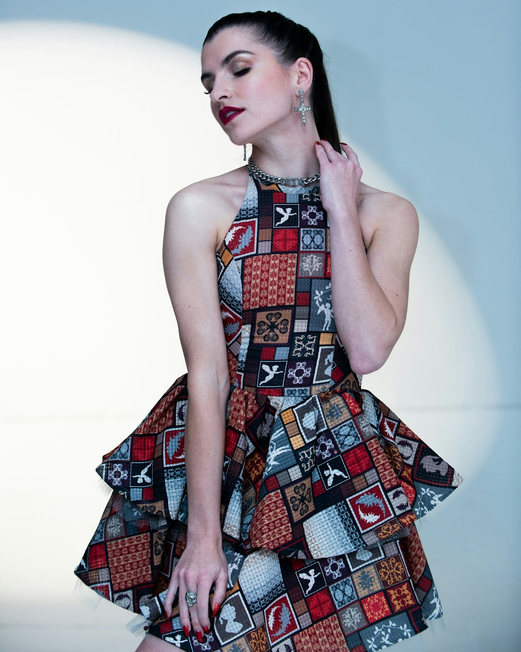 a woman wearing a dress with a pattern on it