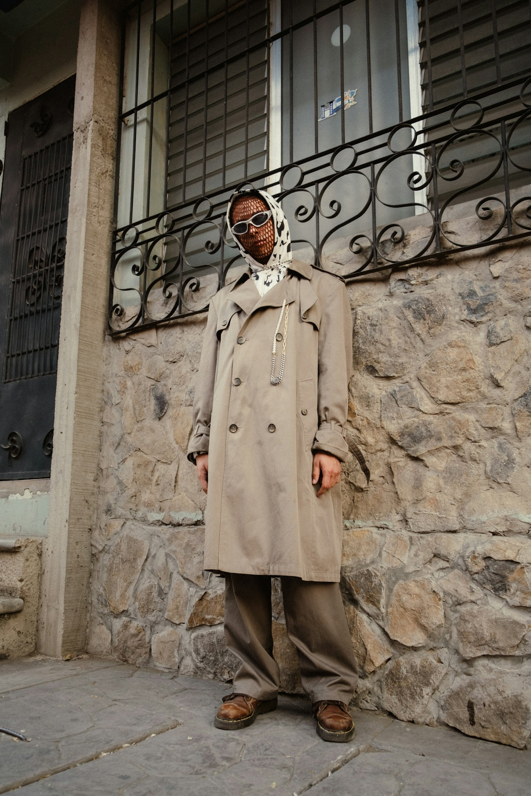 a man standing in front of a stone building