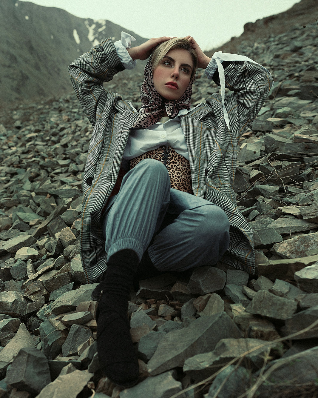 a person sitting on a pile of rocks