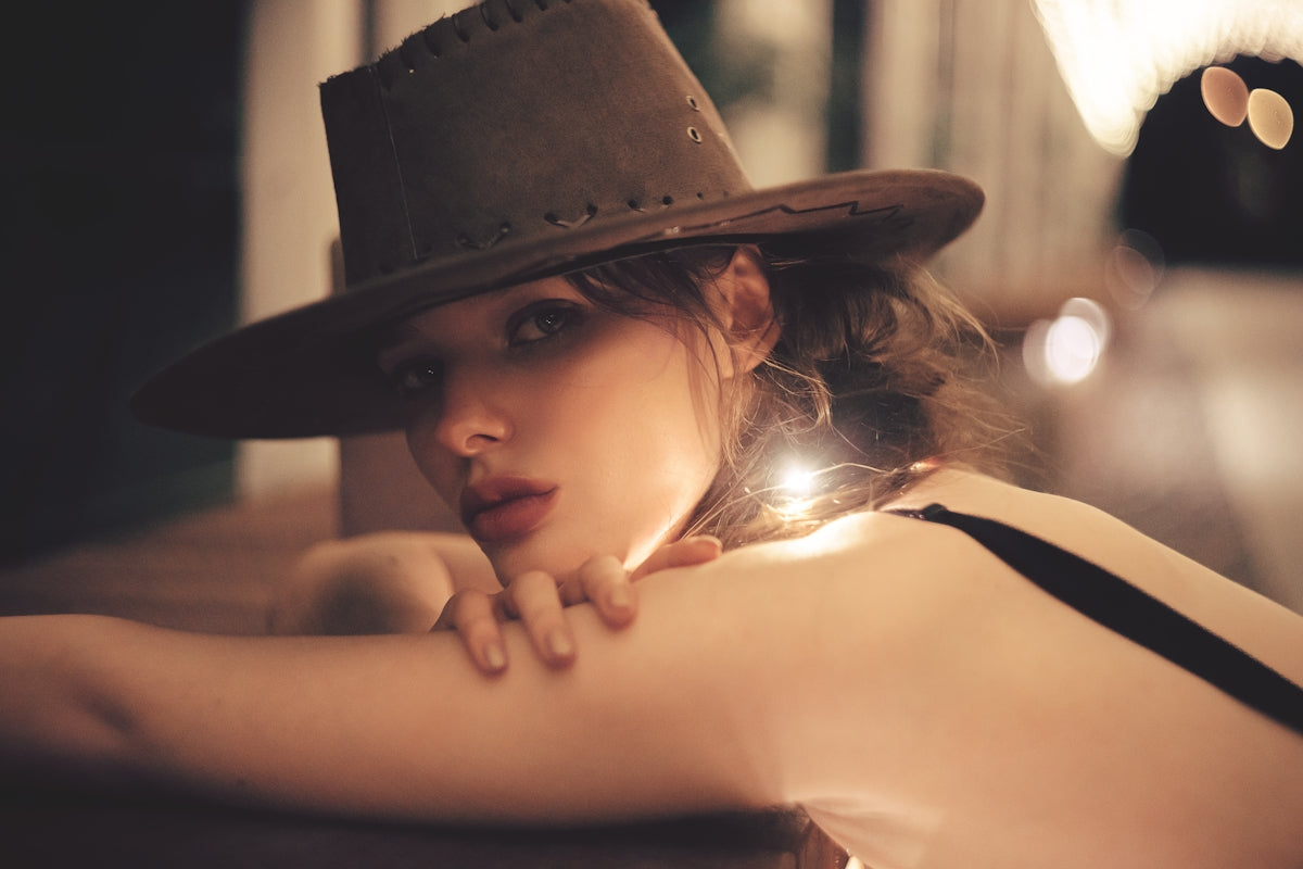 a woman wearing a hat and a black dress