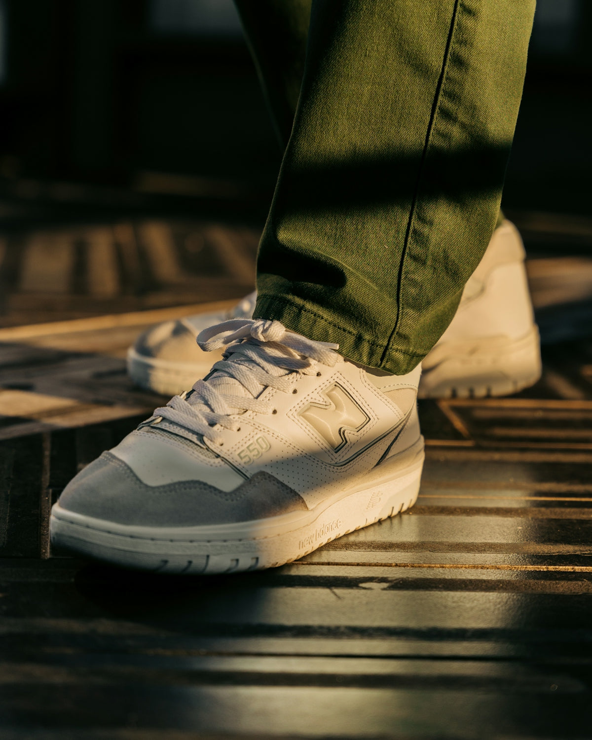 a person's feet in white sneakers
