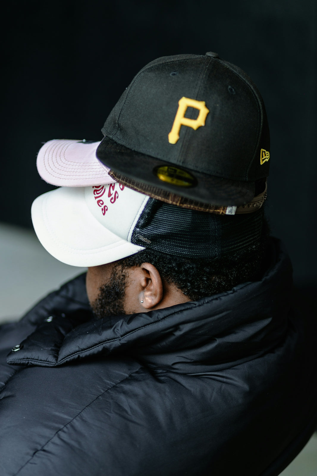 a man wearing a hat with a baseball cap on top of his head