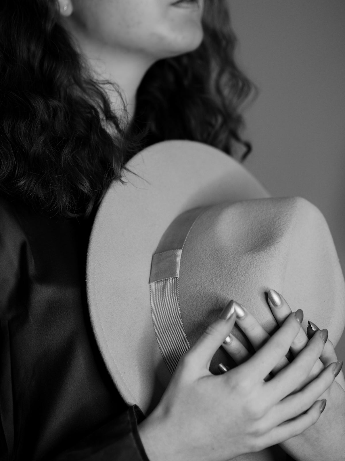 a woman wearing a hat and holding a ring