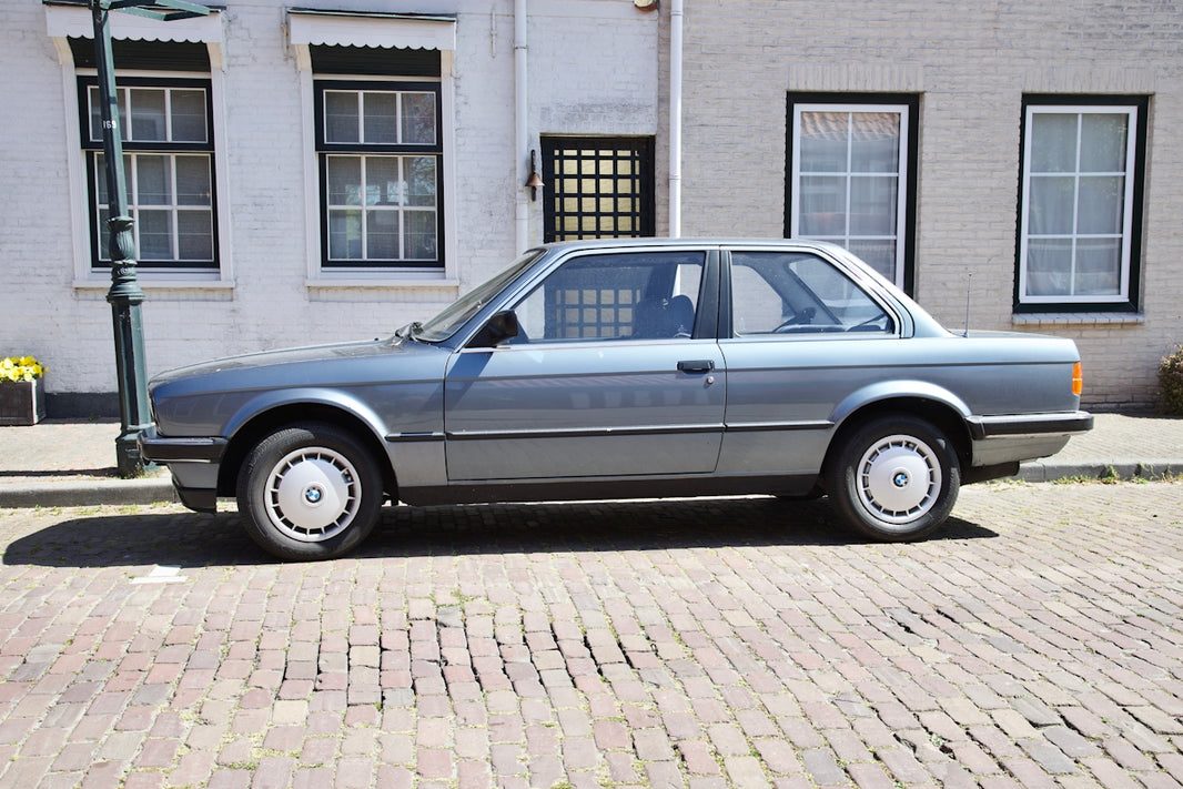 a silver car parked on a brick street