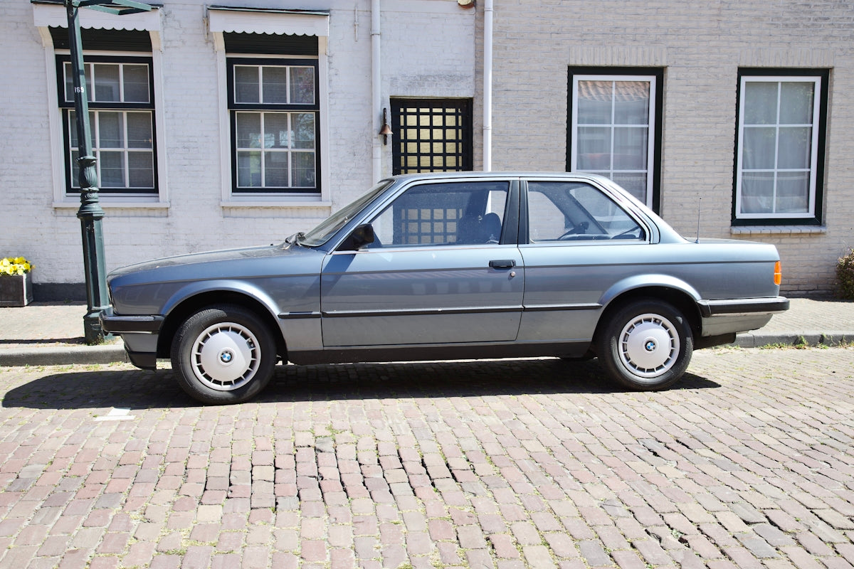 a silver car parked on a brick street