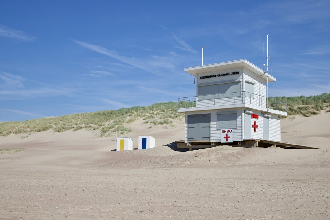 a lifeguard tower sitting on top of a sandy beach