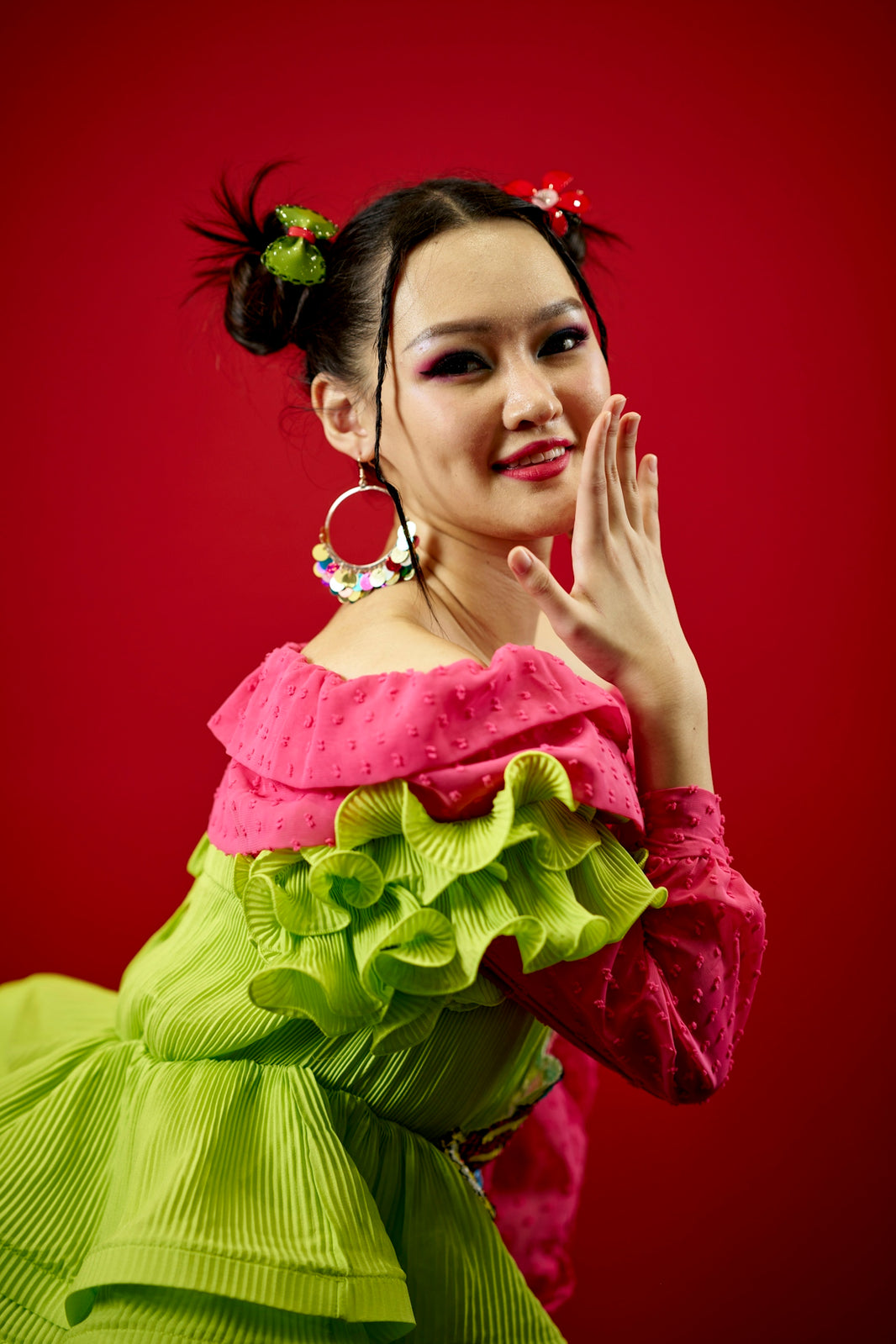 a woman in a green and pink dress