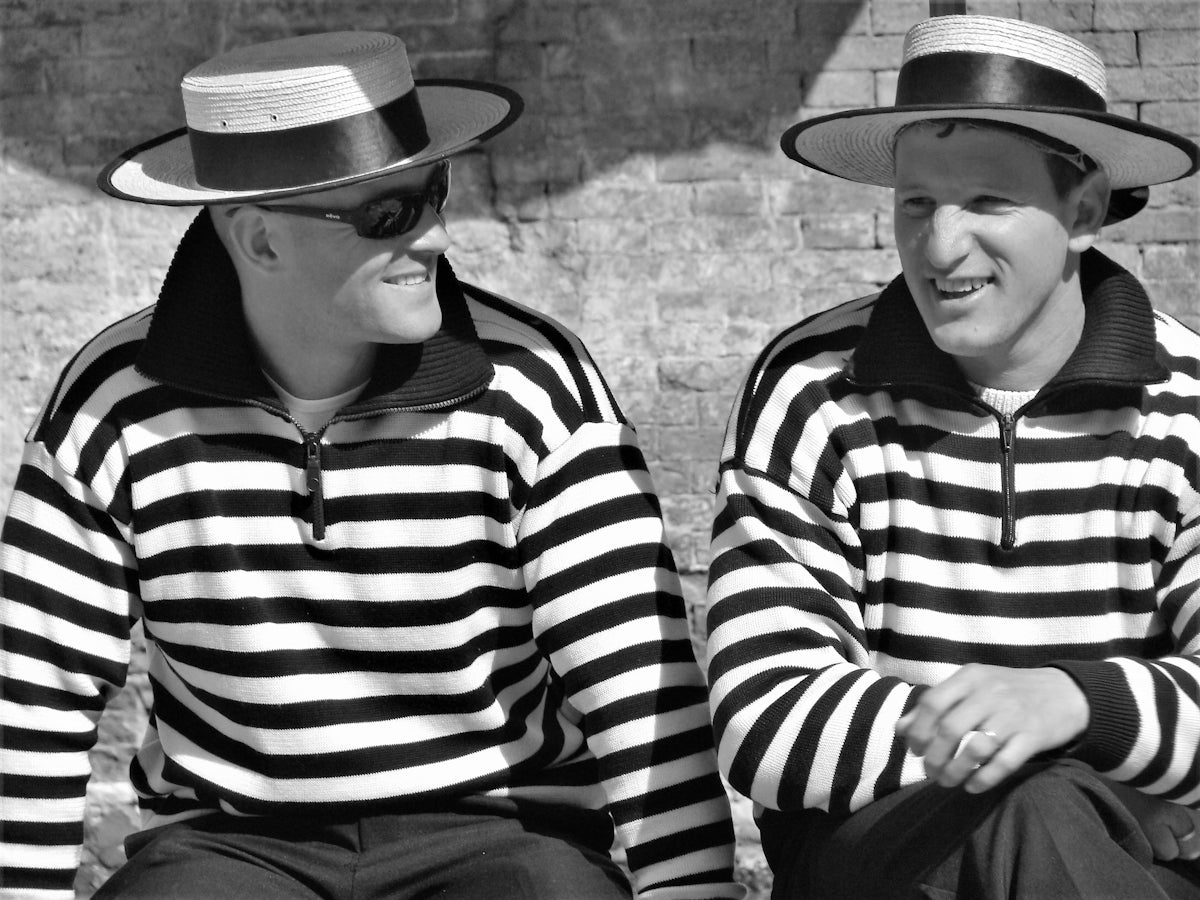 a couple of men sitting next to each other