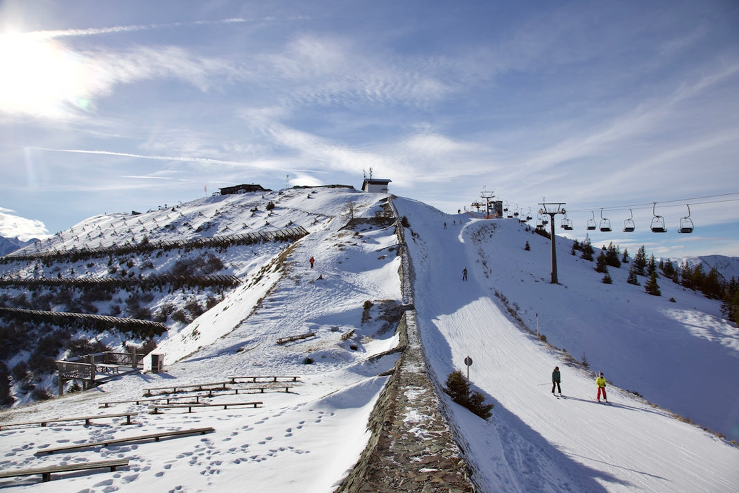 a snow covered mountain with a ski lift in the background