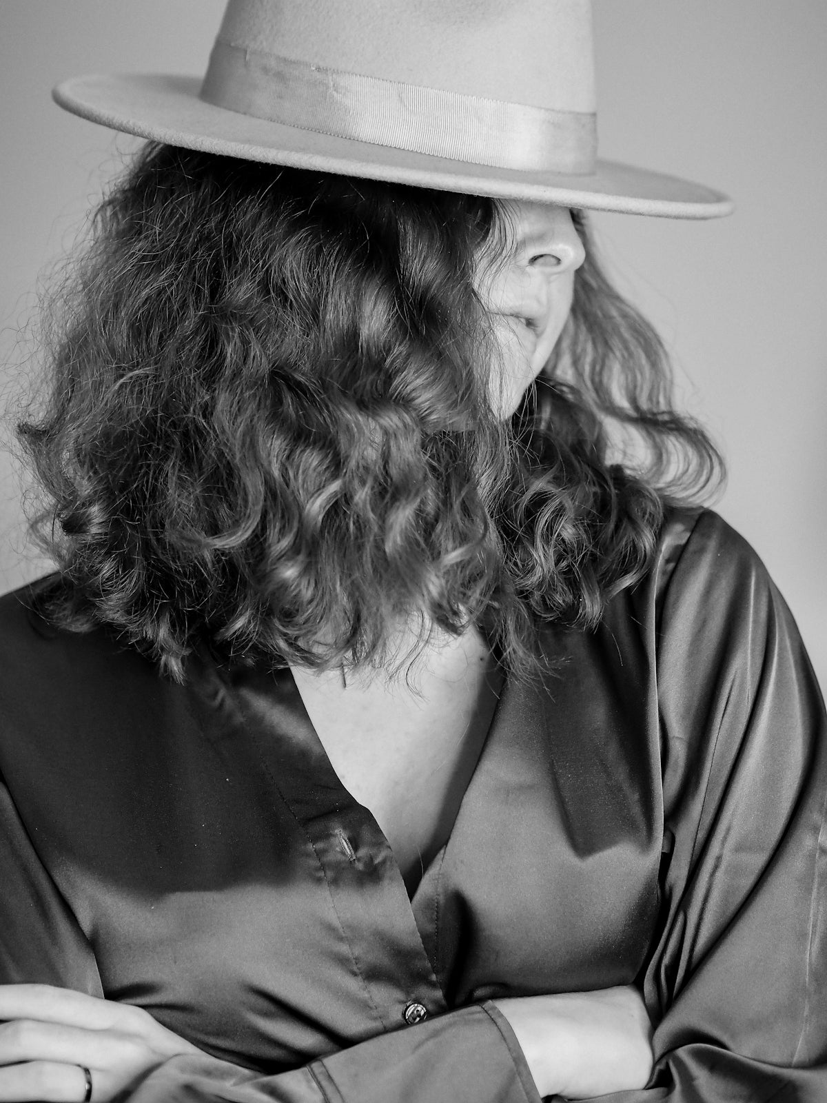 a woman with long hair wearing a hat