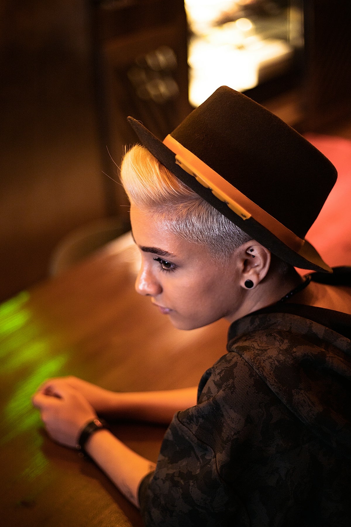 a woman with a top hat sitting at a table