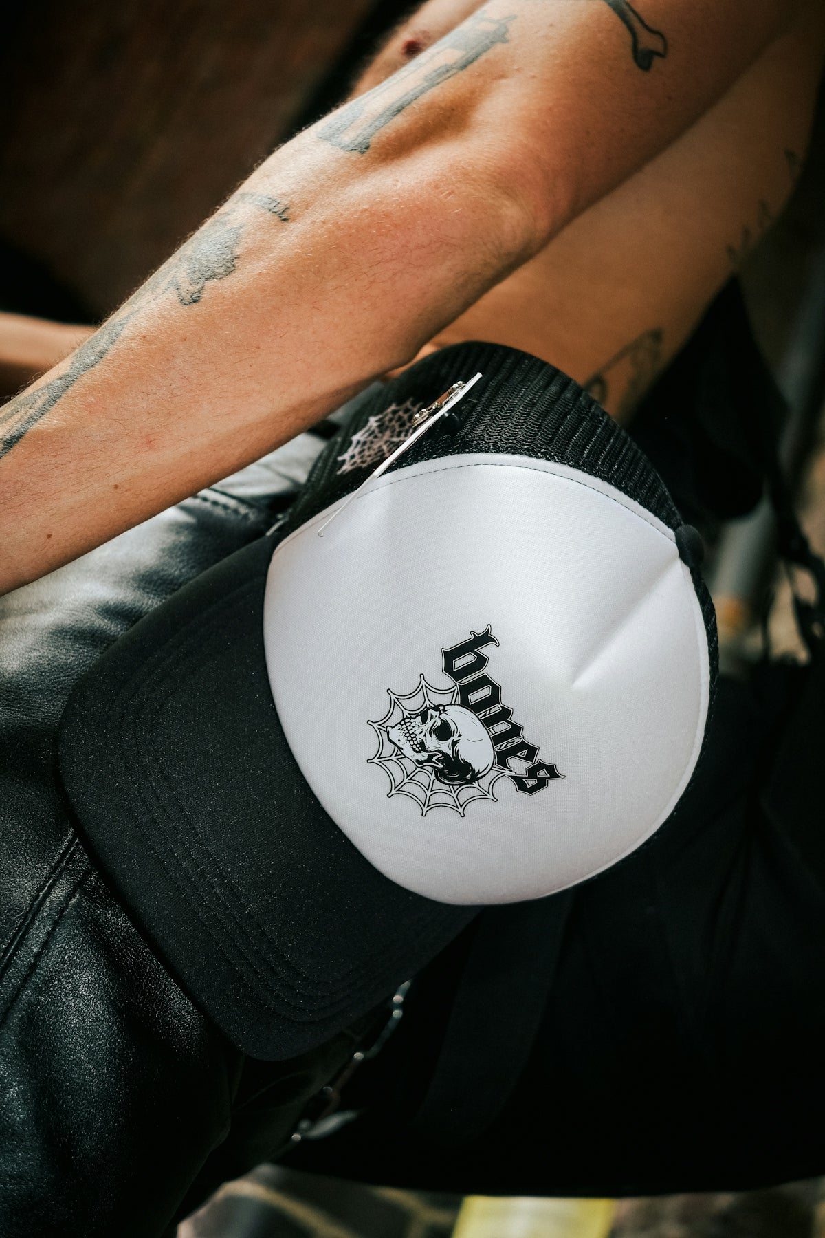 a man with a tattoo sitting on a motorcycle