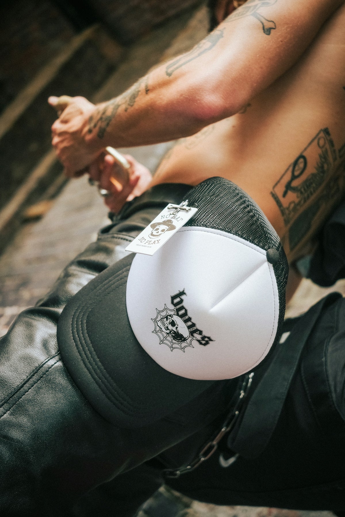 a shirtless man with a tattoo on his arm