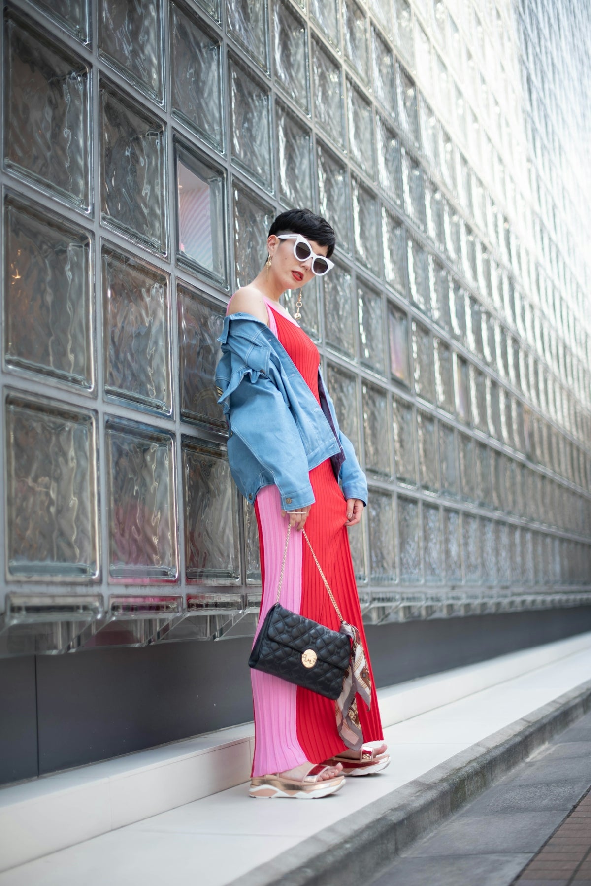 a woman in a red dress and a blue jacket