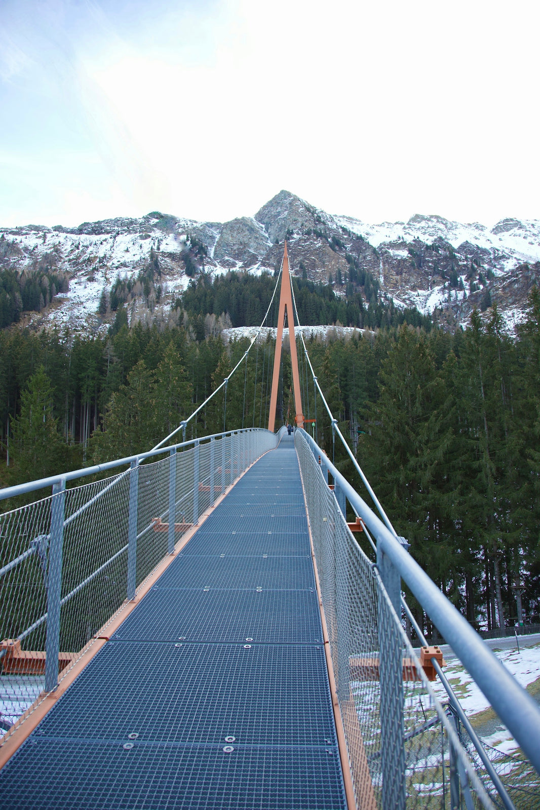 a suspension bridge with a mountain in the background