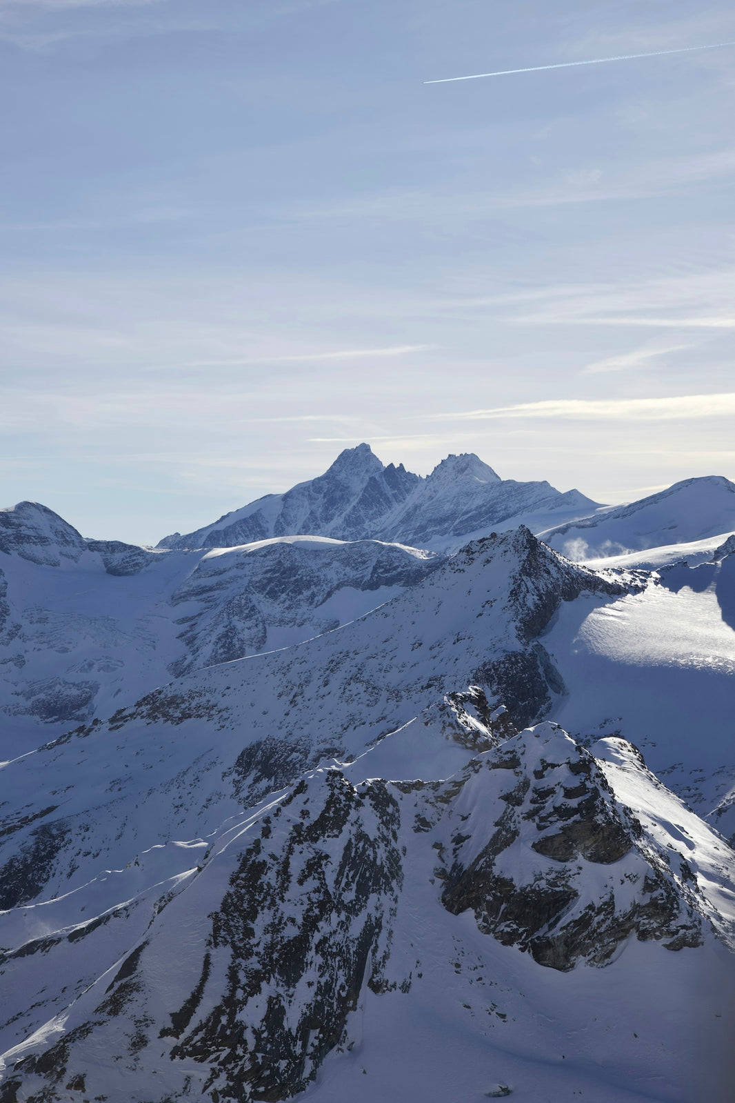 a view of a snowy mountain range from a plane