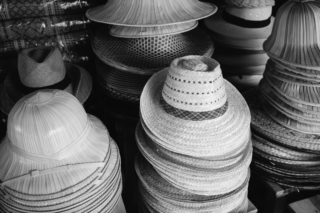 a black and white photo of hats for sale