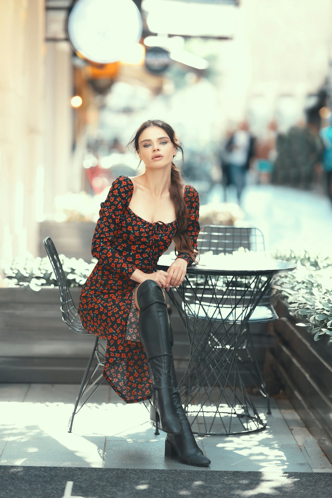 a woman sitting on a chair in front of a table