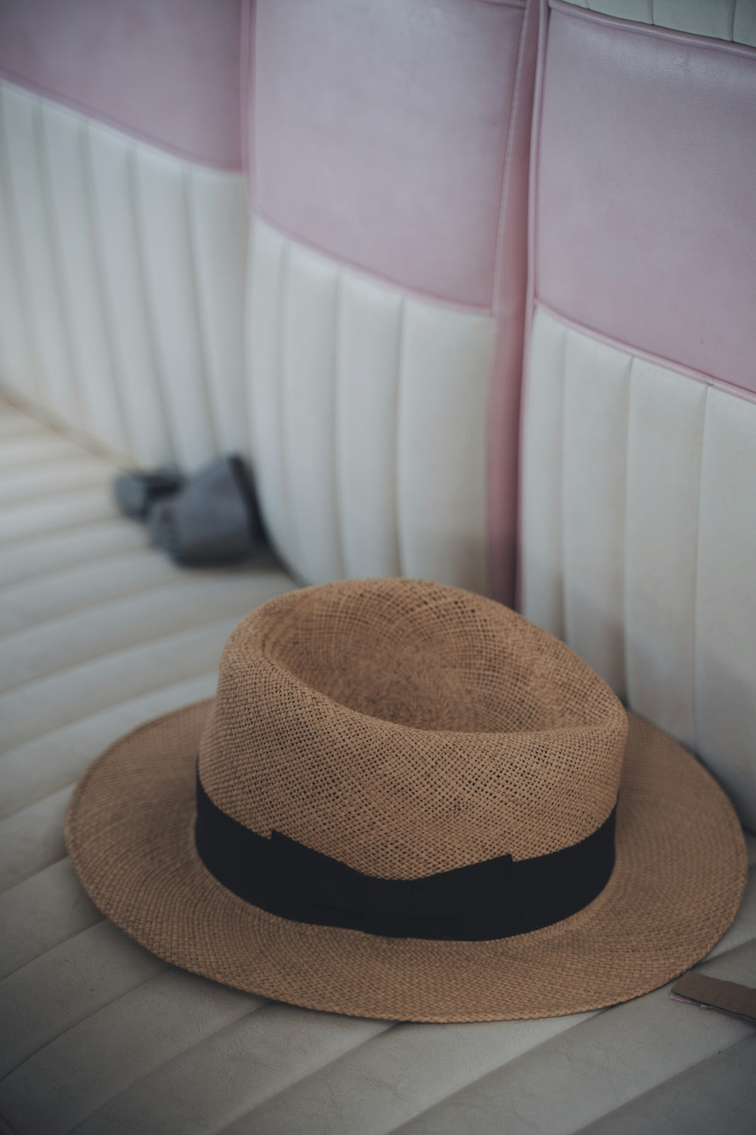 a brown hat sitting on top of a white bench