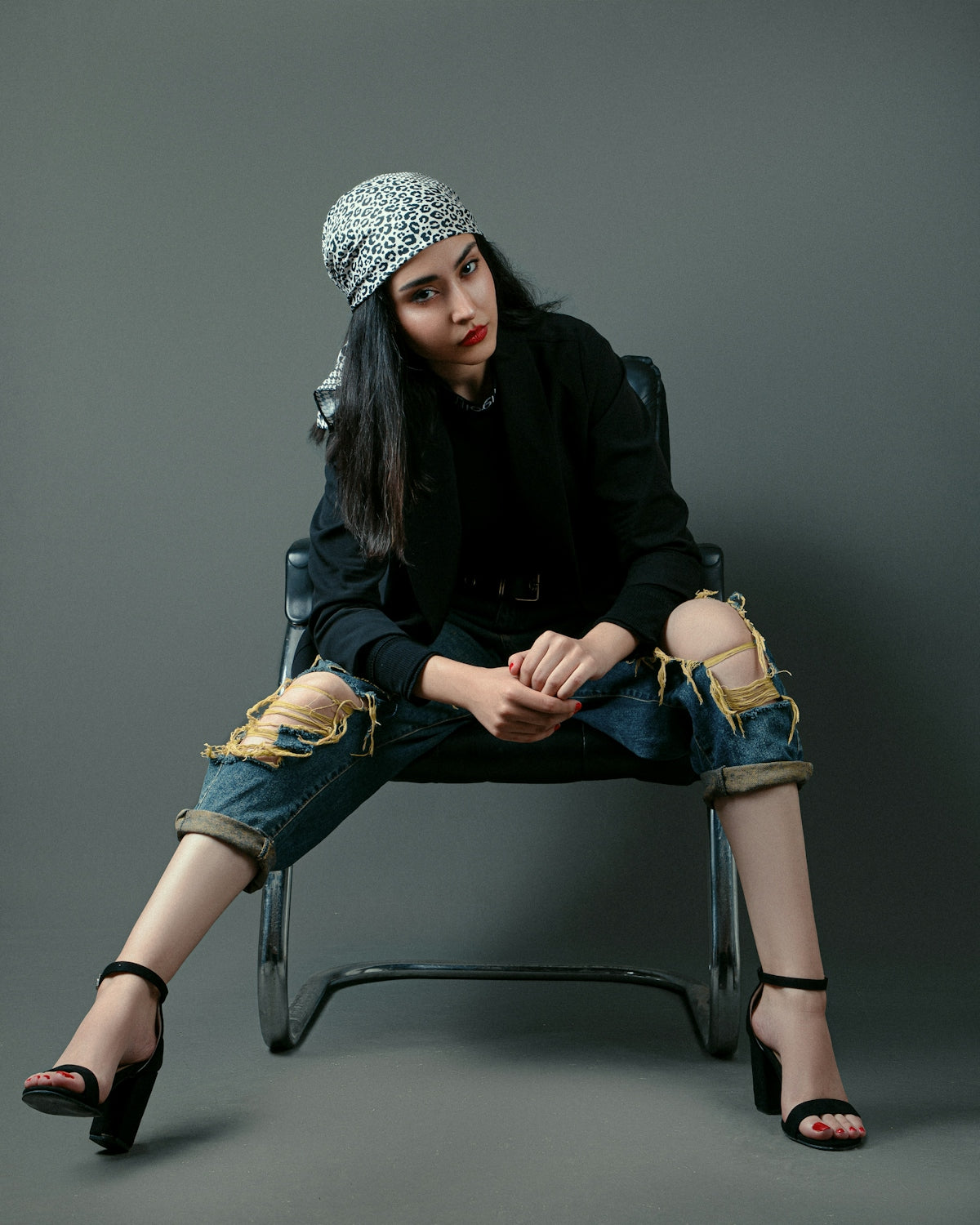 a woman sitting on a chair with her legs crossed