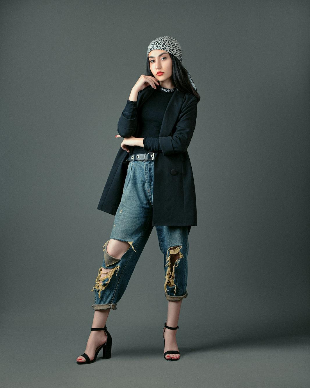 a woman in black jacket and jeans posing for a picture