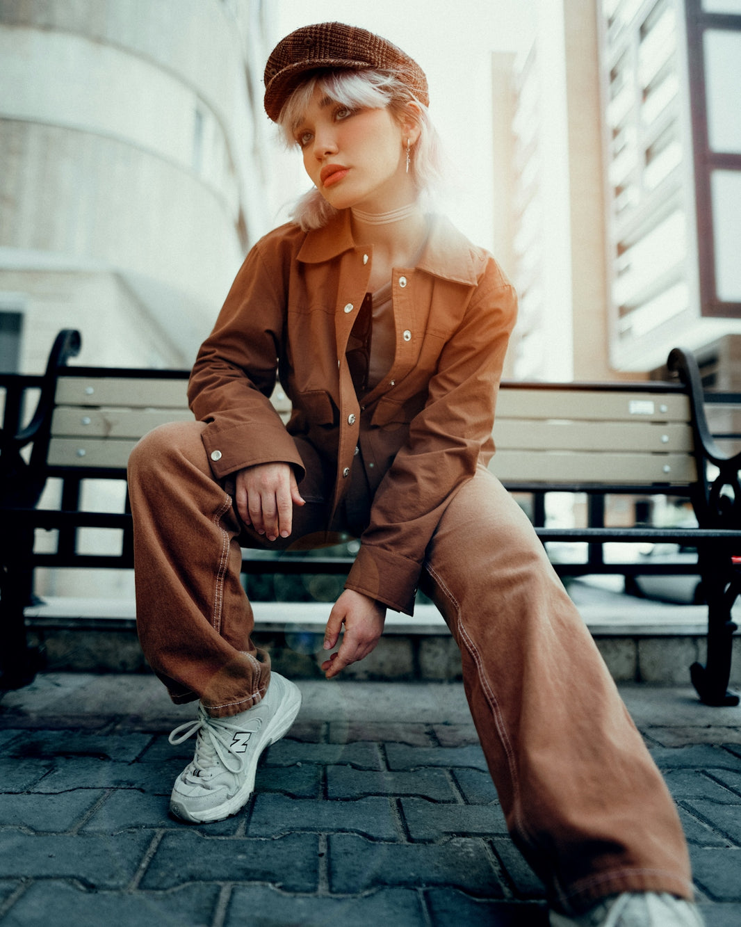 a woman sitting on top of a wooden bench