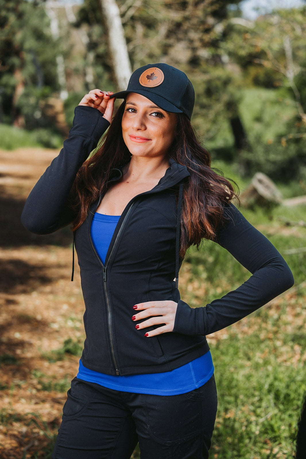 A woman in a black and blue outfit posing for a picture
