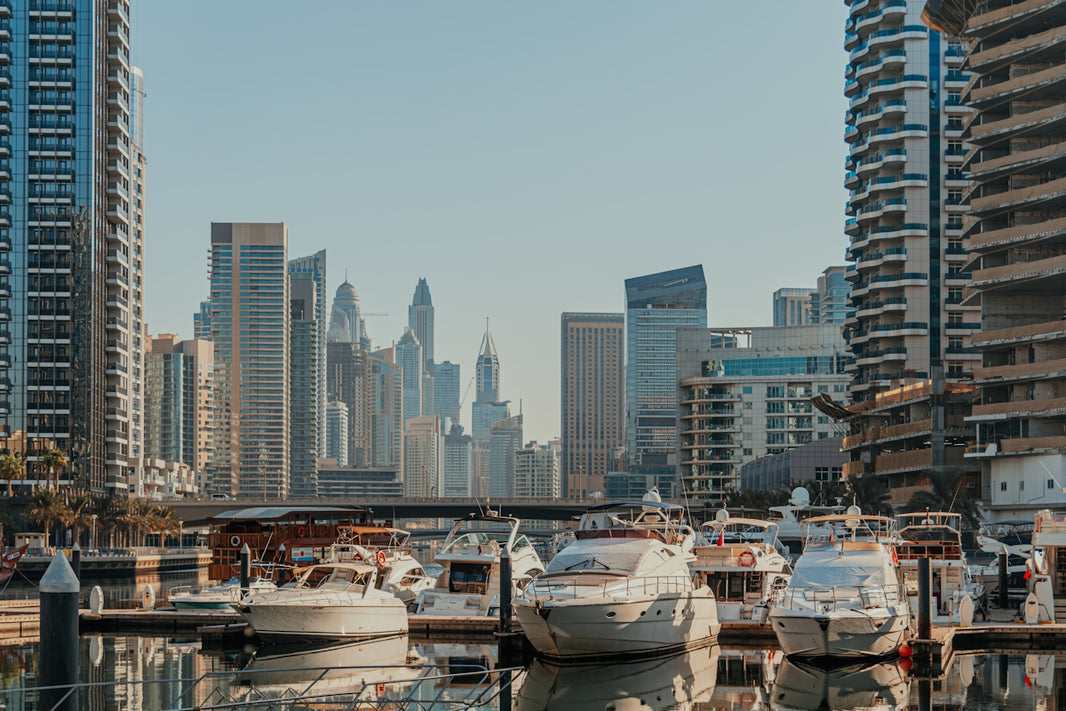 A harbor filled with lots of boats next to tall buildings