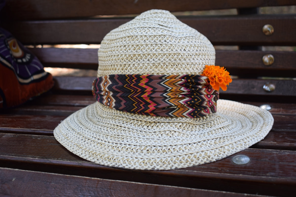 A white hat sitting on top of a wooden bench