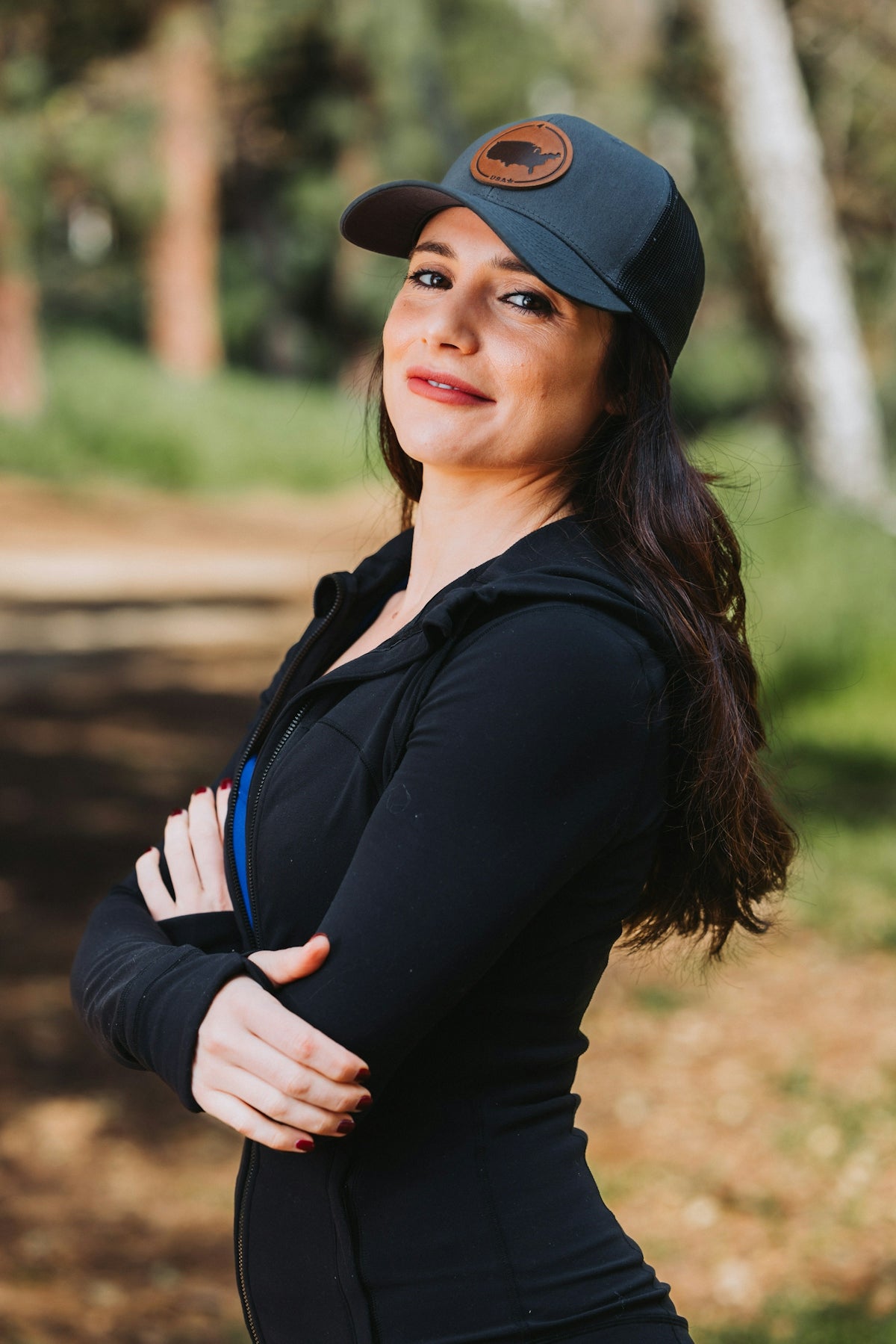 A woman wearing a hat and a black top