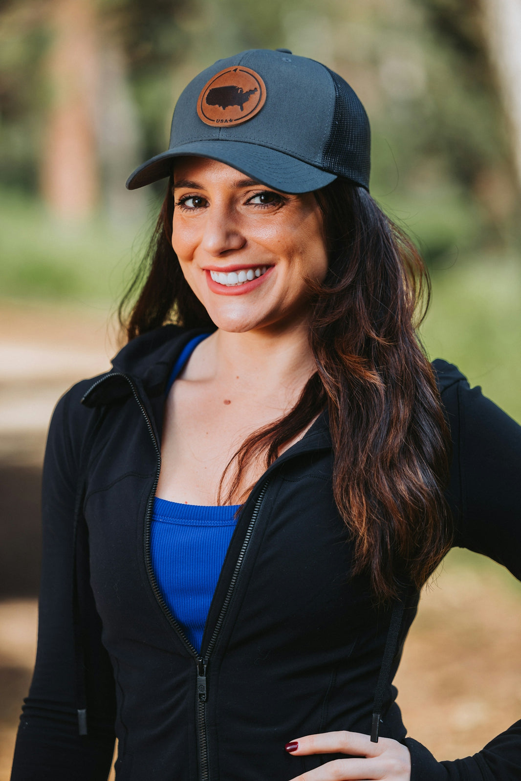 A woman wearing a black jacket and a hat