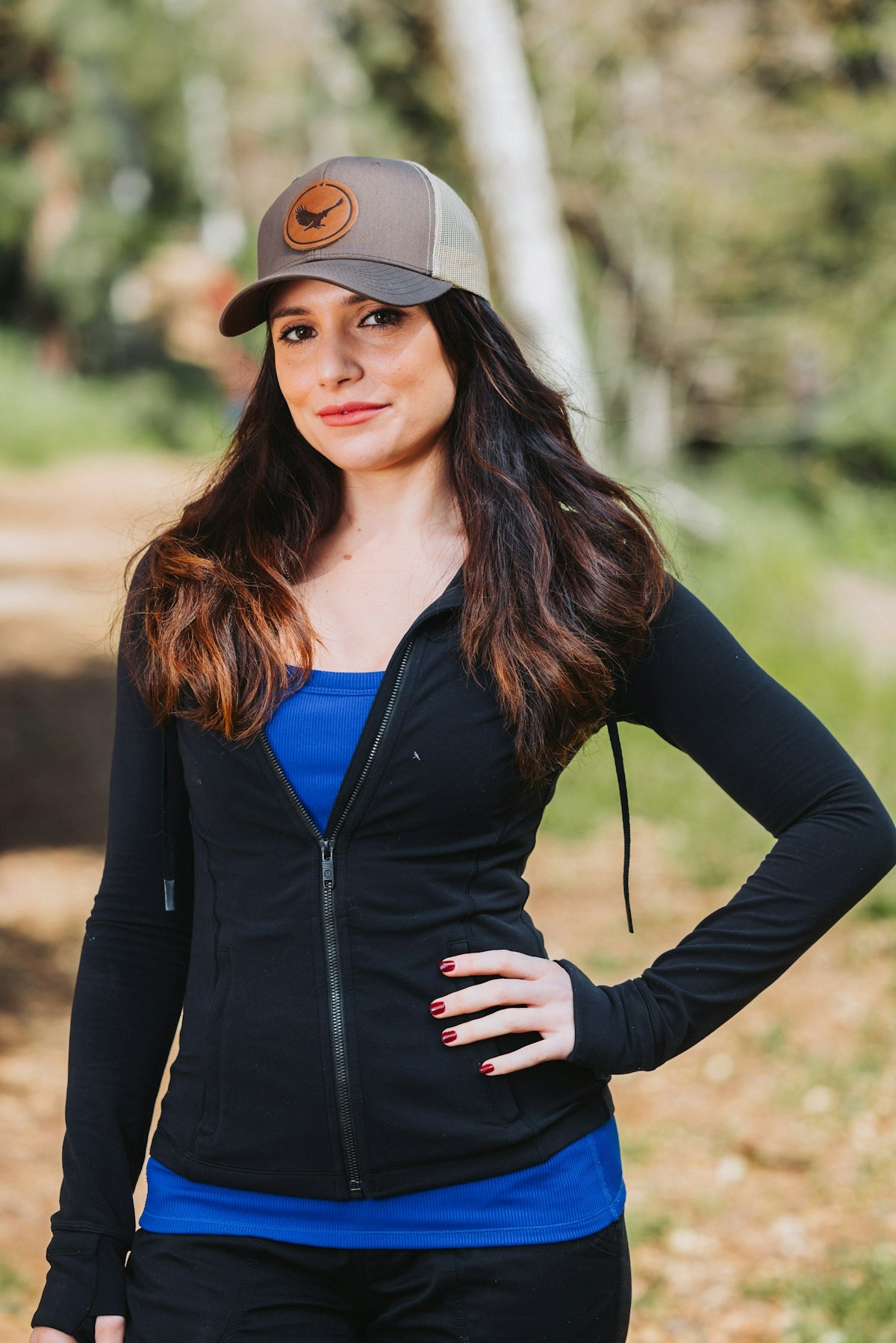 A woman wearing a hat and a black jacket