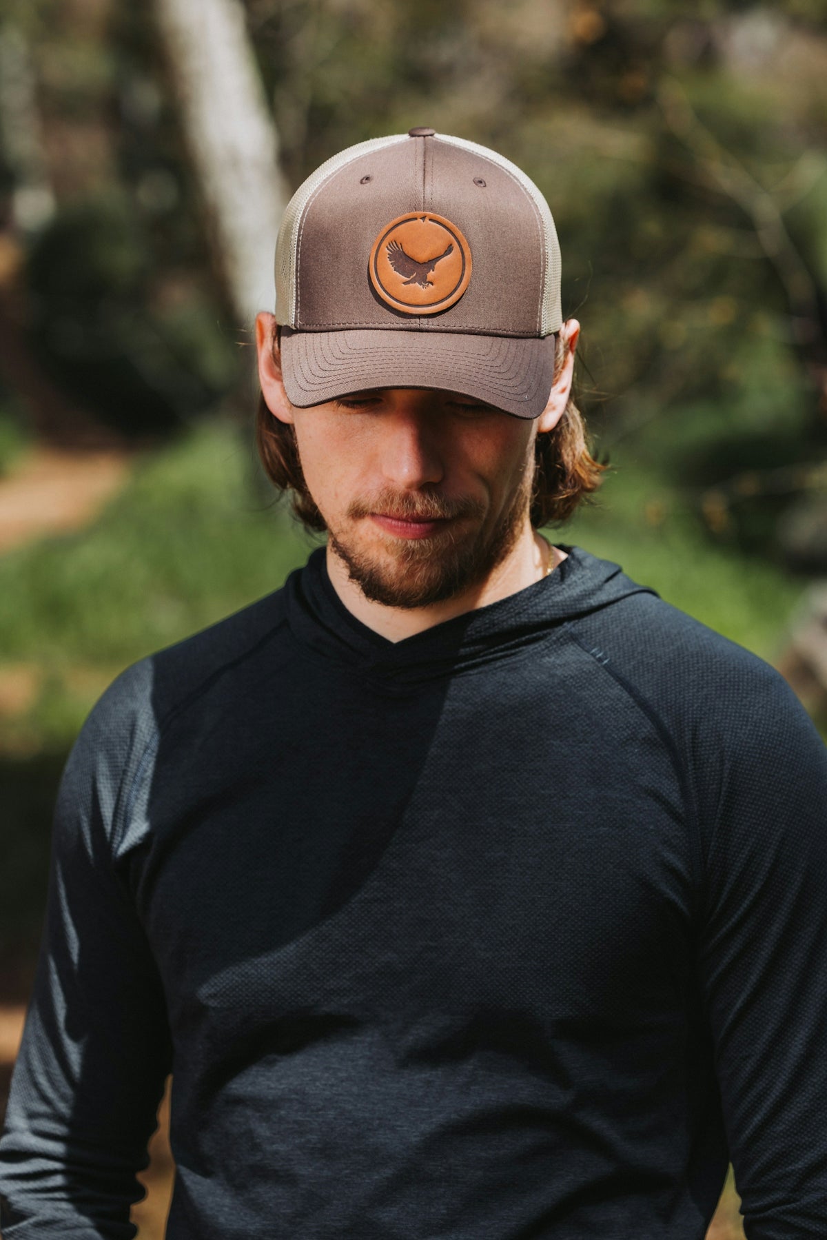 A man in a black shirt and a brown hat