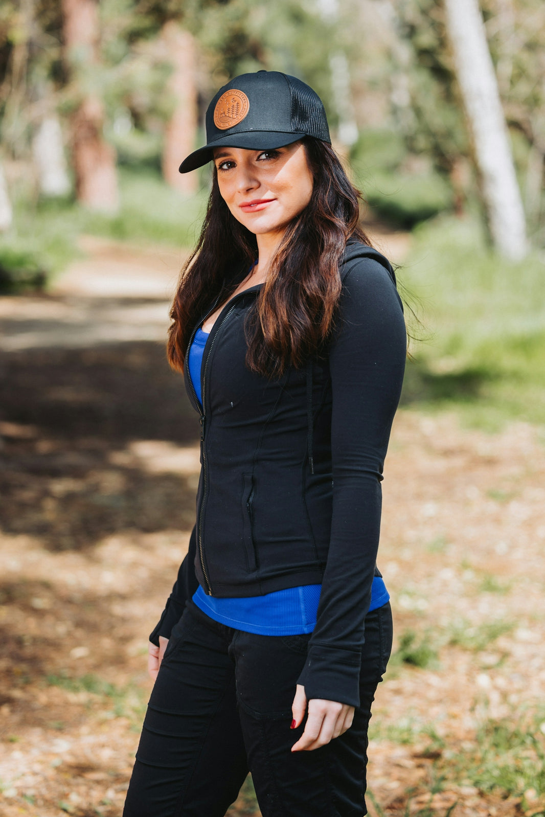 A woman wearing a black hat and black pants