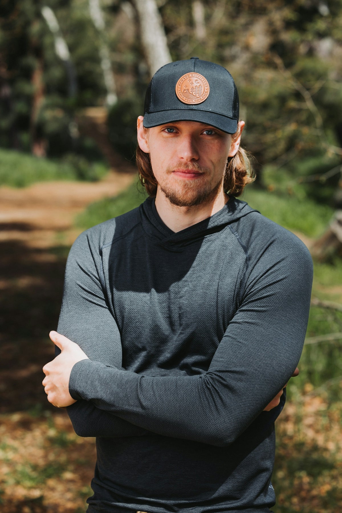 A man wearing a hat with his arms crossed