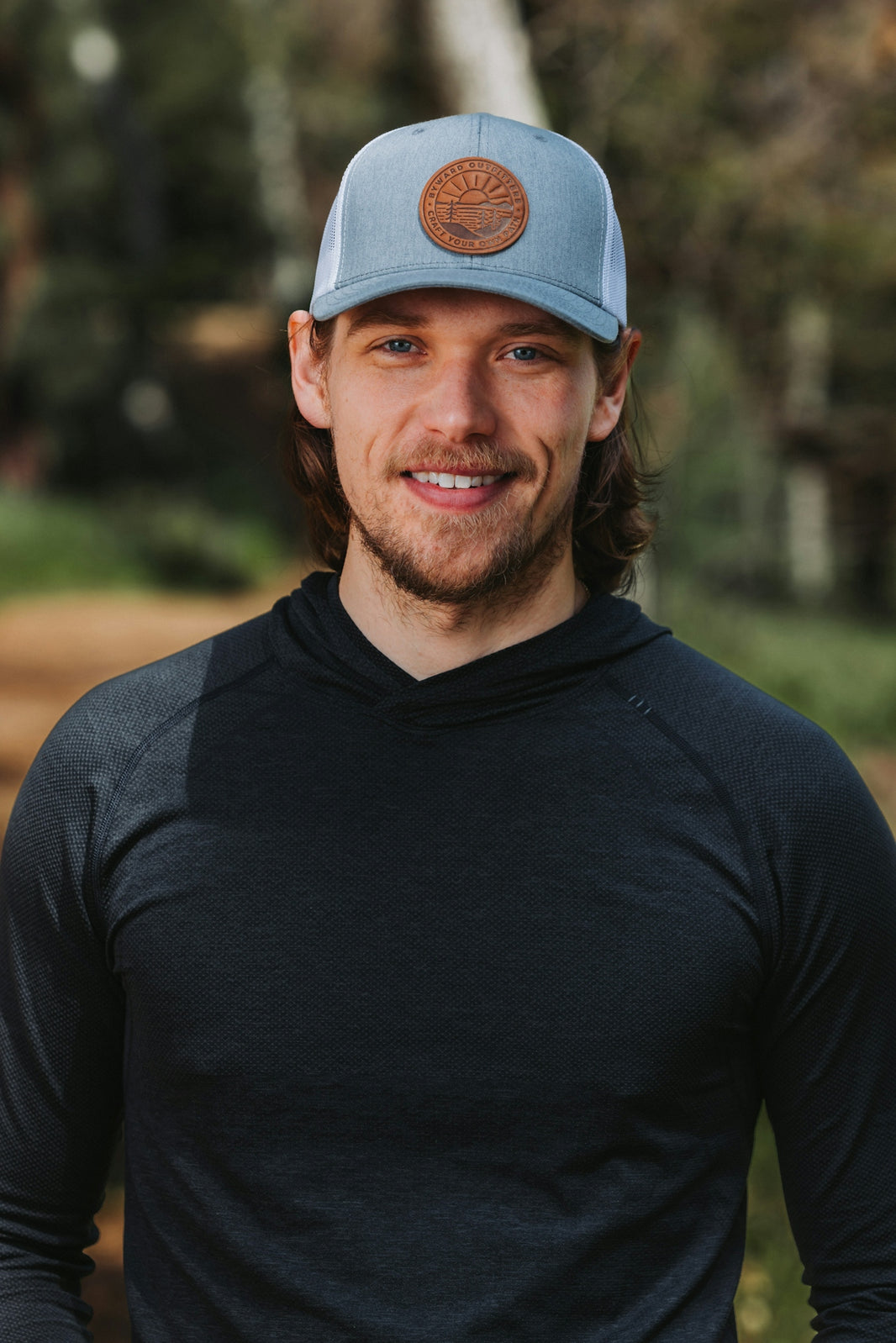 A man wearing a blue hat and black shirt