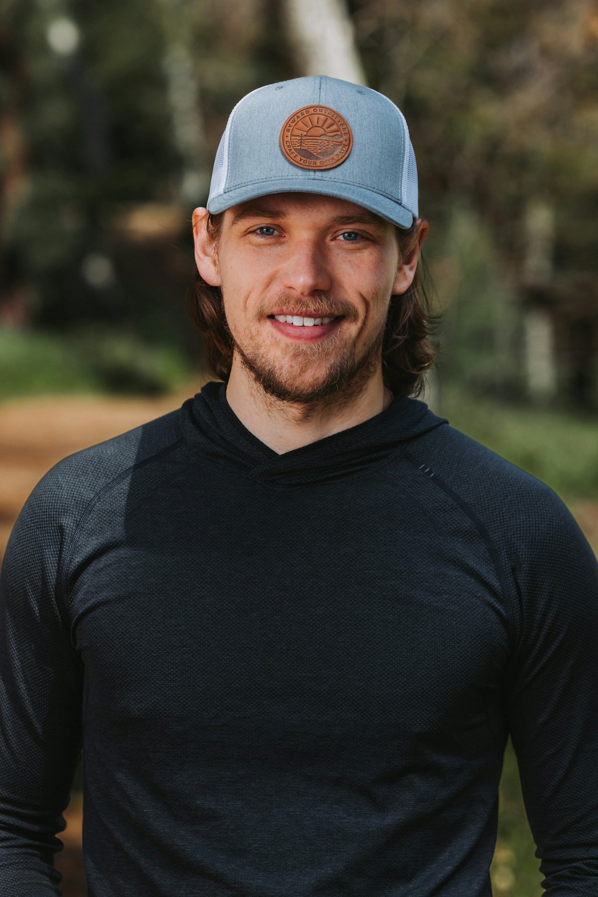 A man wearing a blue hat and black shirt