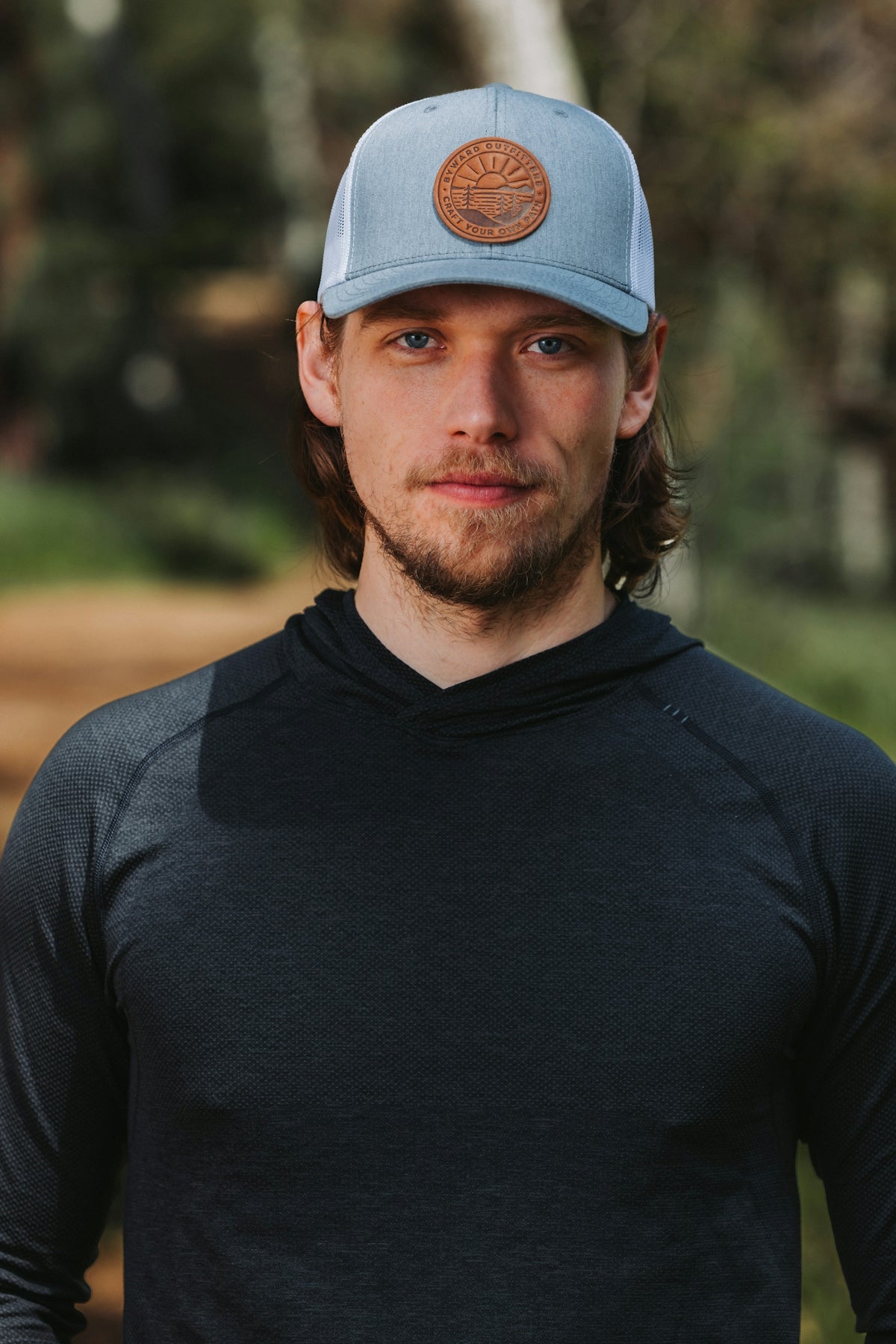 A man in a black shirt and a blue hat