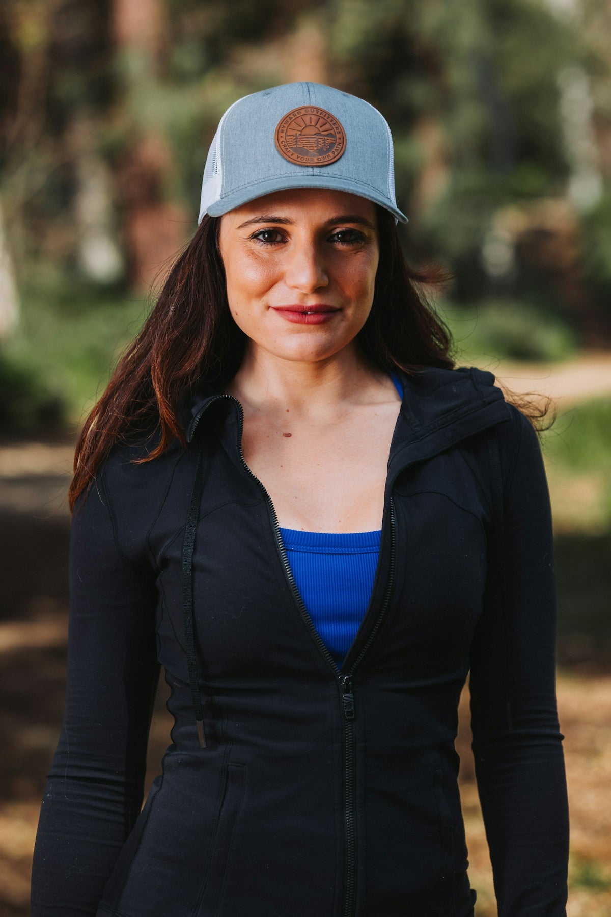 A woman wearing a blue hat and black jacket
