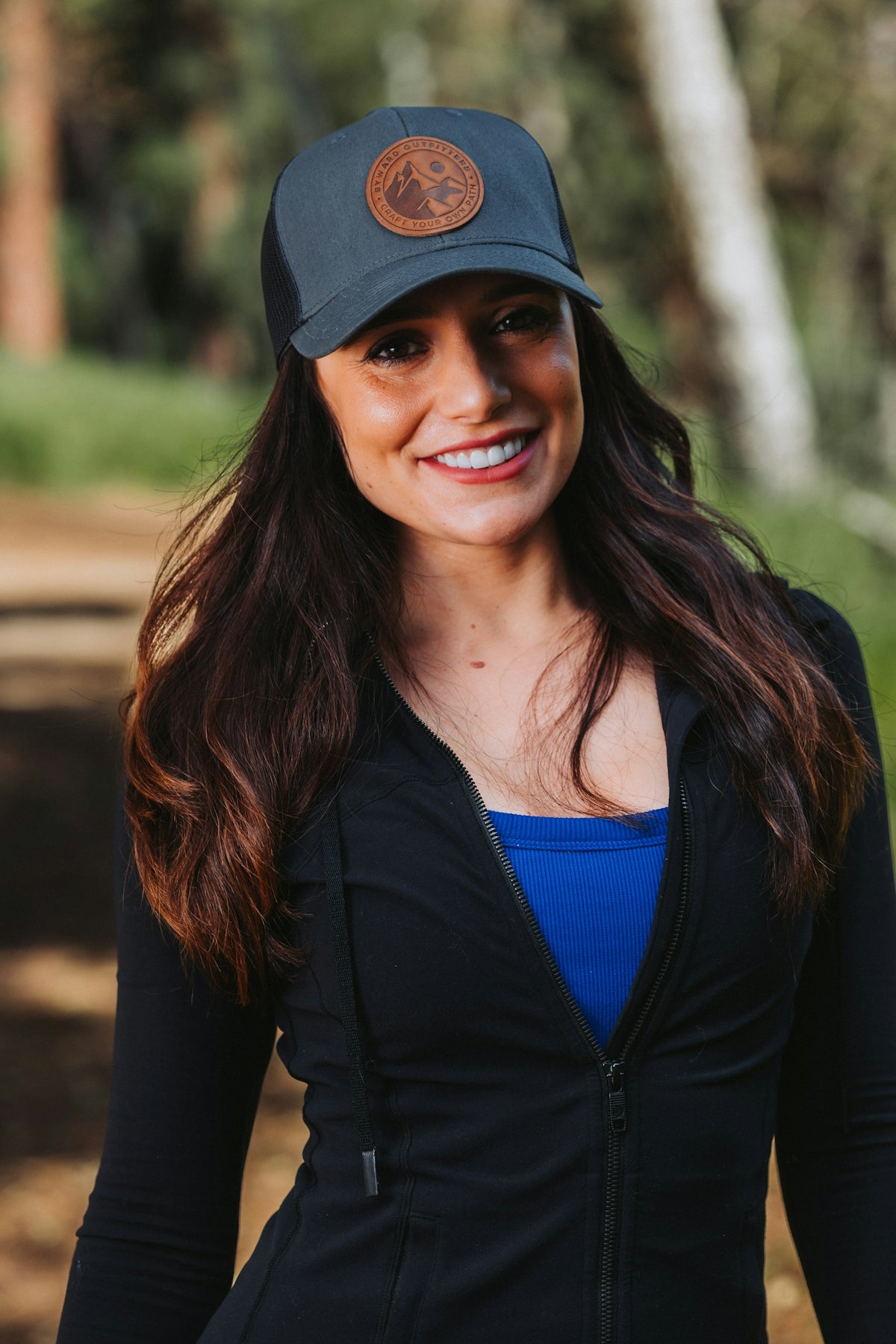 A woman wearing a hat and smiling for the camera