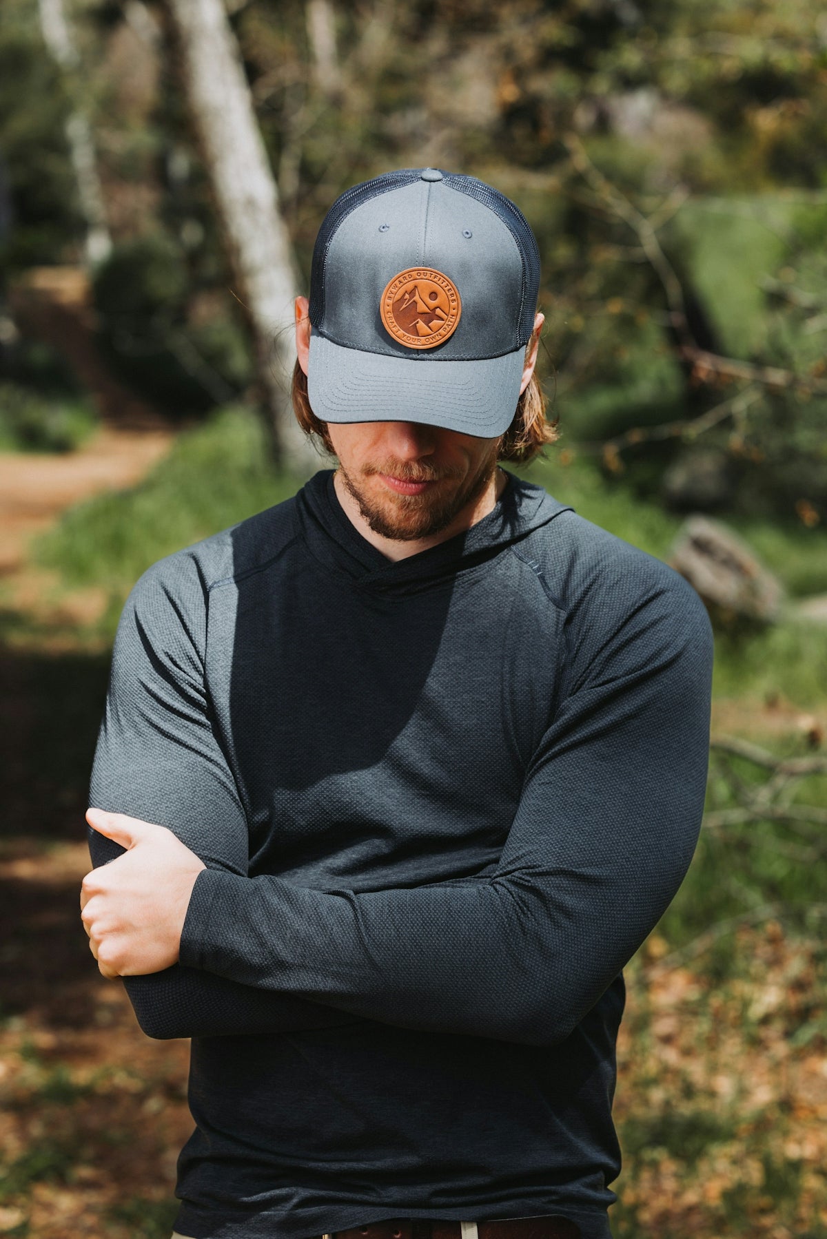 A man wearing a hat with a button on it