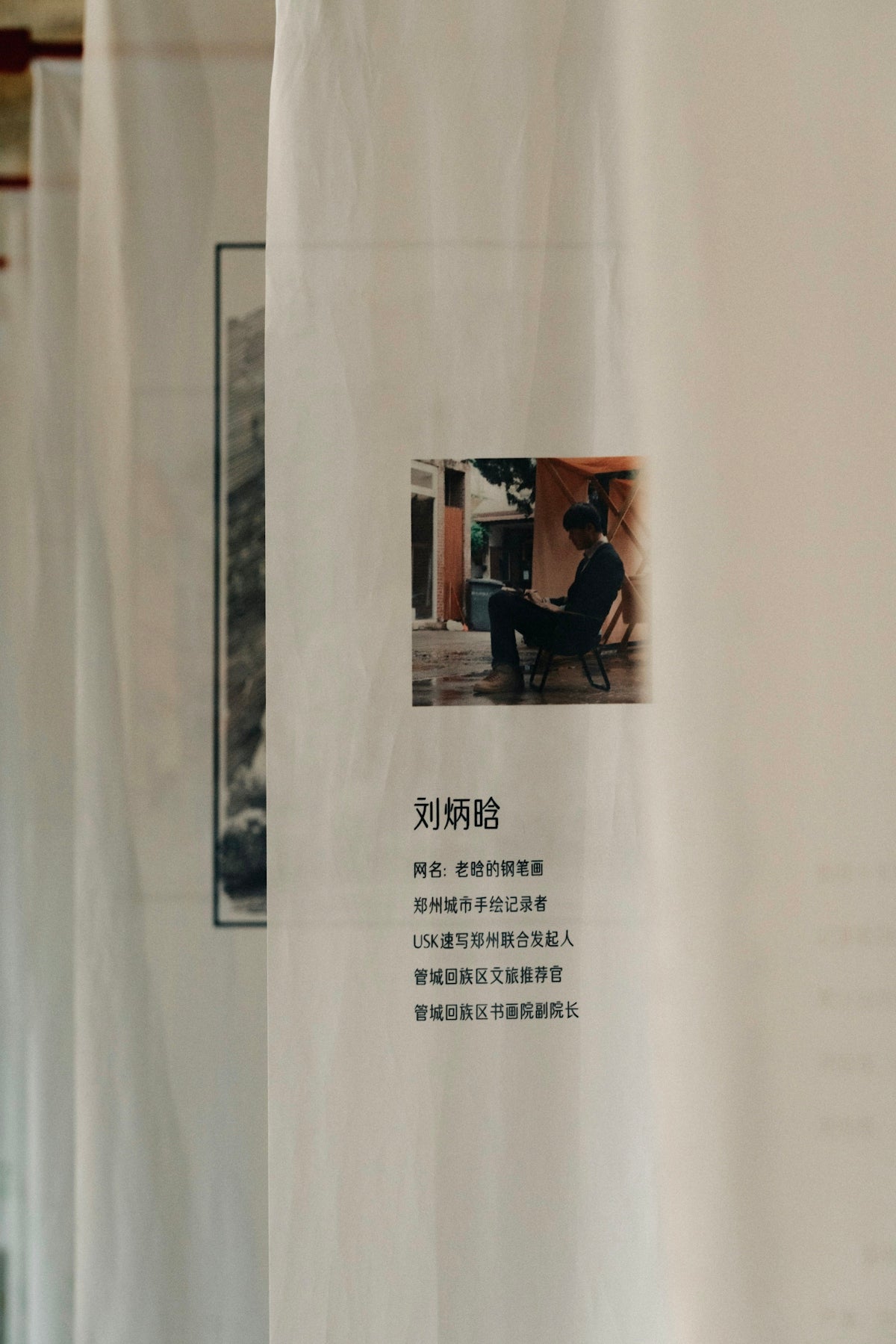 A photo of a person sitting in a chair in a room