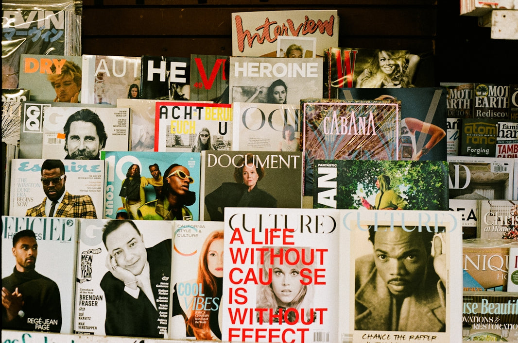 A bunch of magazines are stacked on a wall