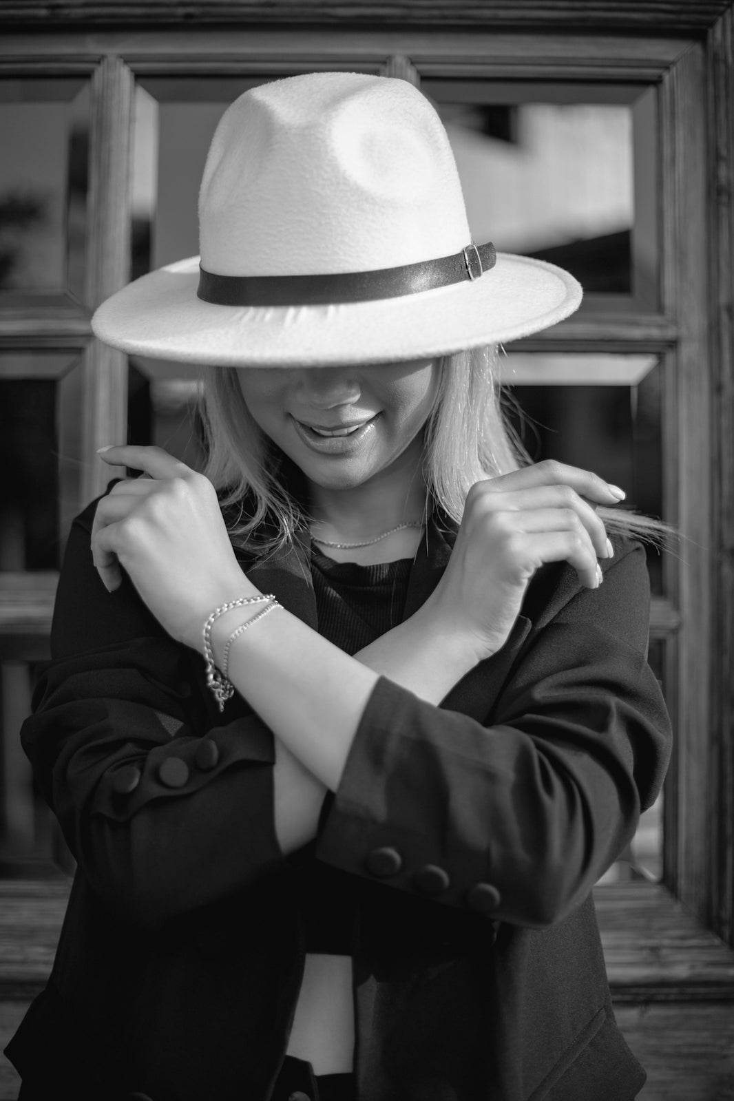 A woman wearing a hat and smoking a cigarette