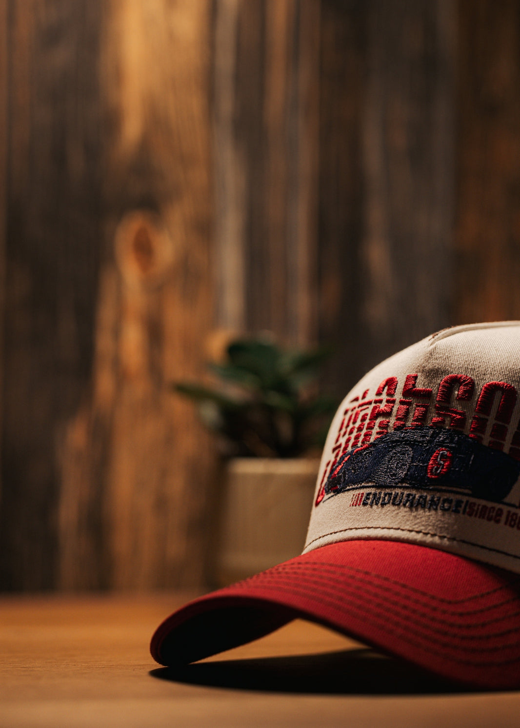A red and white hat sitting on top of a wooden table